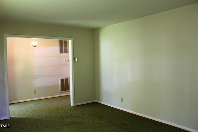 2071 Meadow Ln, Graham, NC 27253 - empty room with dark colored carpet and baseboards
