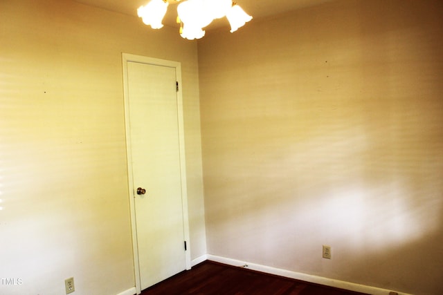2071 Meadow Ln, Graham, NC 27253 - spare room featuring dark wood finished floors and a chandelier