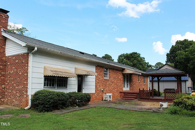 2071 Meadow Ln, Graham, NC 27253 - back of house featuring a gazebo, a yard, brick siding, and a chimney