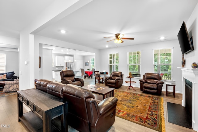 7117 Crested Iris Pl, Durham, NC 27703 - living area featuring ceiling fan, light wood-style floors, a fireplace, and recessed lighting