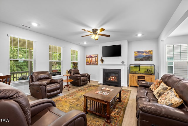 7117 Crested Iris Pl, Durham, NC 27703 - living room with light wood finished floors, ceiling fan, recessed lighting, and a fireplace with flush hearth