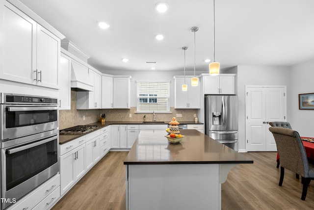 7117 Crested Iris Pl, Durham, NC 27703 - kitchen featuring stainless steel appliances, dark countertops, recessed lighting, white cabinetry, and tasteful backsplash