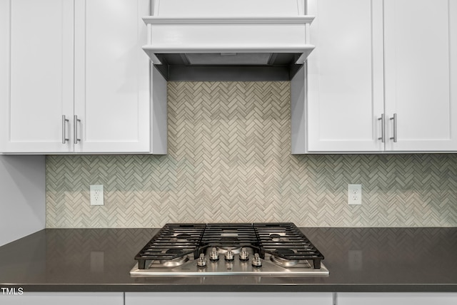 7117 Crested Iris Pl, Durham, NC 27703 - kitchen with stainless steel gas cooktop, custom range hood, dark countertops, and tasteful backsplash
