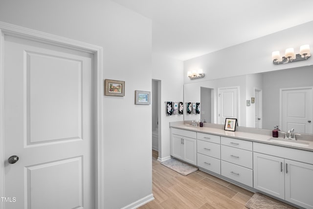 7117 Crested Iris Pl, Durham, NC 27703 - bathroom with double vanity and wood finished floors