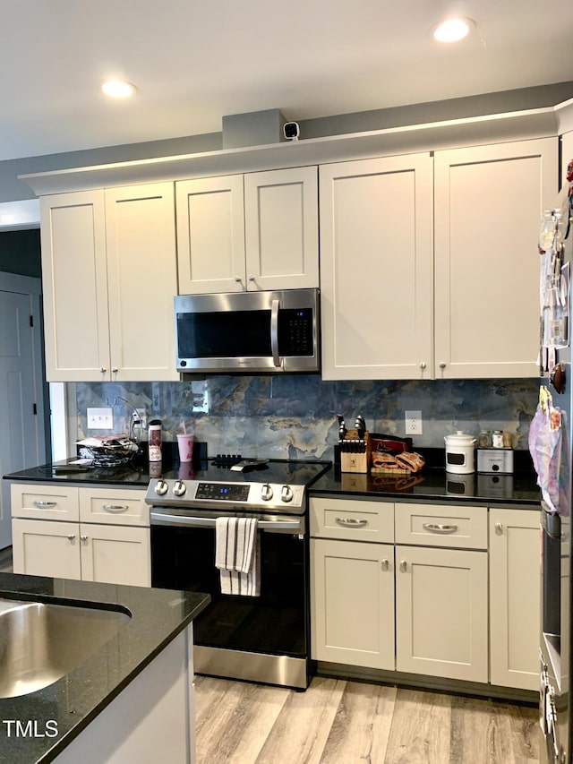 55 Running Deer Path, Timberlake, NC 27583 - kitchen featuring stainless steel appliances, light wood-style flooring, decorative backsplash, white cabinetry, and recessed lighting