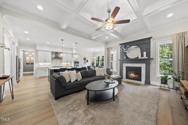 1325 Mackinaw Dr, Wake Forest, NC 27587 - living room featuring a ceiling fan, recessed lighting, coffered ceiling, light wood finished floors, and a glass covered fireplace