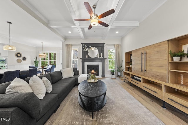 1325 Mackinaw Dr, Wake Forest, NC 27587 - living area featuring wood finished floors, ceiling fan, a glass covered fireplace, beamed ceiling, and coffered ceiling