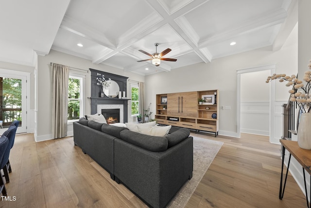 1325 Mackinaw Dr, Wake Forest, NC 27587 - living area featuring coffered ceiling, a warm lit fireplace, recessed lighting, light wood-style flooring, and ceiling fan