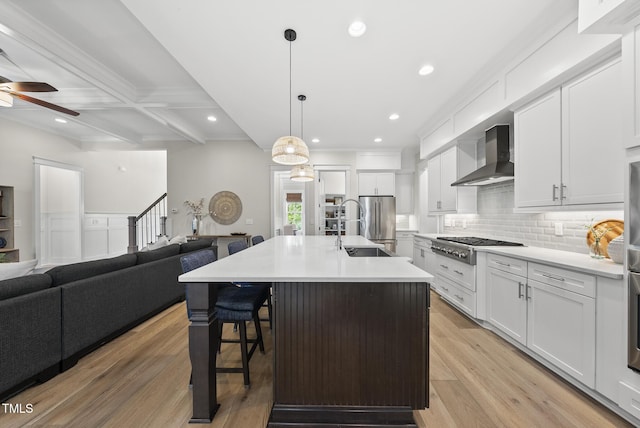 1325 Mackinaw Dr, Wake Forest, NC 27587 - kitchen featuring wall chimney range hood, a ceiling fan, stainless steel appliances, open floor plan, and recessed lighting