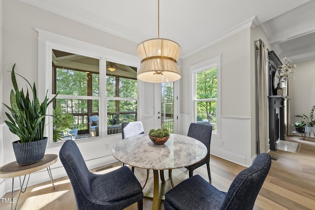 1325 Mackinaw Dr, Wake Forest, NC 27587 - dining space featuring light wood-type flooring, wainscoting, and crown molding