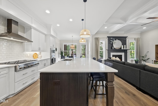 1325 Mackinaw Dr, Wake Forest, NC 27587 - kitchen with stainless steel appliances, wall chimney exhaust hood, a kitchen breakfast bar, open floor plan, and tasteful backsplash