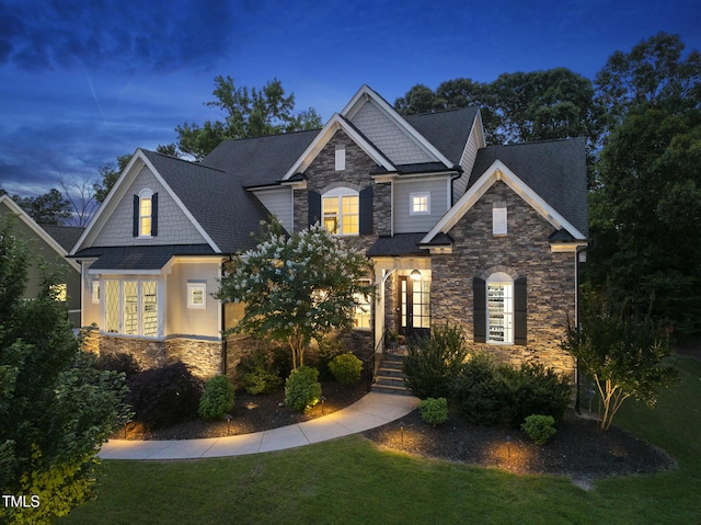 1325 Mackinaw Dr, Wake Forest, NC 27587 - craftsman-style home featuring stone siding, a front yard, and a shingled roof