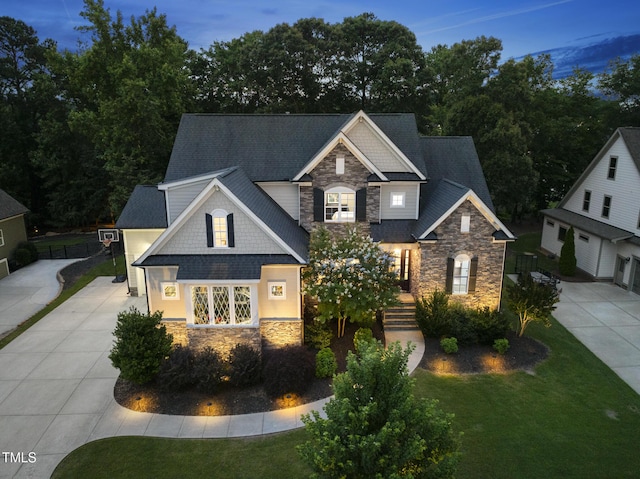1325 Mackinaw Dr, Wake Forest, NC 27587 - craftsman-style house featuring stone siding, driveway, and a front lawn