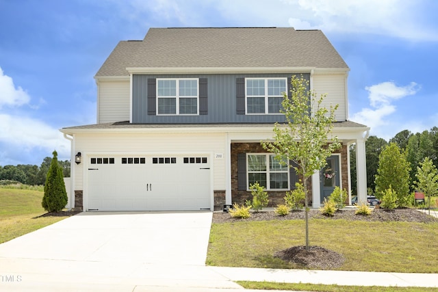 200 Sweet Violet Dr, Youngsville, NC 27596 - view of front of property featuring driveway, a front lawn, an attached garage, and stone siding