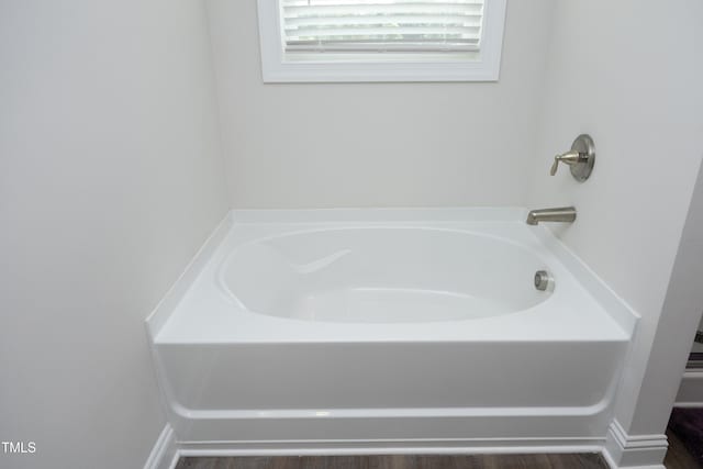 200 Sweet Violet Dr, Youngsville, NC 27596 - bathroom with a garden tub and wood finished floors