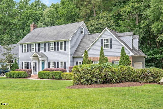 2008 Corberrie Ln, Raleigh, NC 27613 - colonial-style house featuring a chimney, a front yard, a shingled roof, and an attached garage