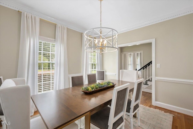 2008 Corberrie Ln, Raleigh, NC 27613 - dining space featuring a chandelier, wood finished floors, crown molding, and stairway