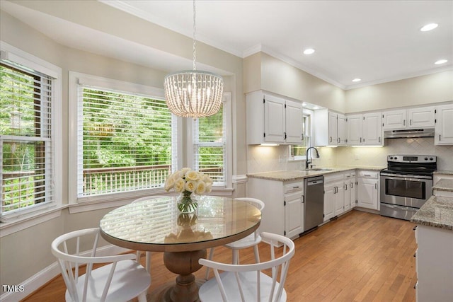 2008 Corberrie Ln, Raleigh, NC 27613 - kitchen with appliances with stainless steel finishes, under cabinet range hood, a chandelier, plenty of natural light, and crown molding