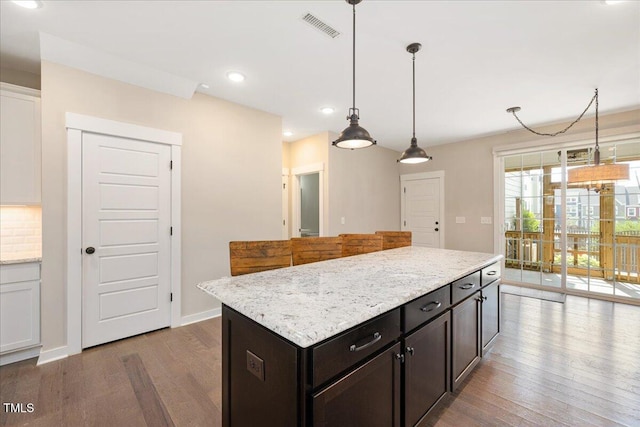 513 Brooks St, Wake Forest, NC 27587 - kitchen featuring wood finished floors, recessed lighting, decorative light fixtures, light stone countertops, and a center island