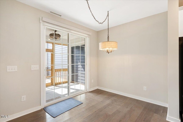 513 Brooks St, Wake Forest, NC 27587 - unfurnished dining area with a chandelier and wood finished floors