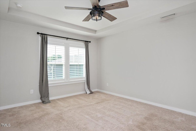 513 Brooks St, Wake Forest, NC 27587 - empty room with a tray ceiling, carpet, ceiling fan, and a smoke detector