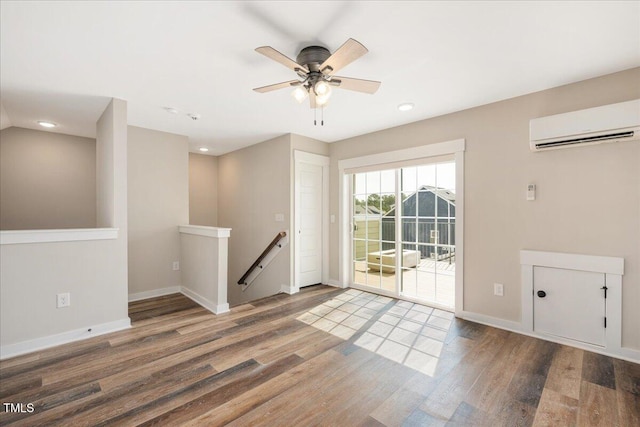 513 Brooks St, Wake Forest, NC 27587 - empty room featuring a wall mounted air conditioner, wood finished floors, ceiling fan, and recessed lighting