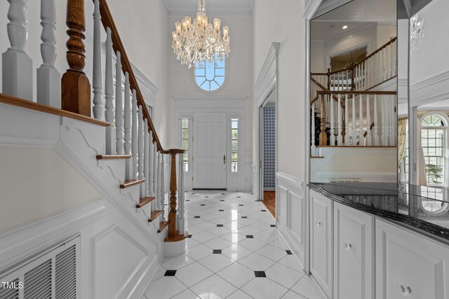 4315 Sugar Pine Ln, Durham, NC 27705 - foyer entrance with a chandelier, stairs, plenty of natural light, light tile patterned flooring, and a high ceiling