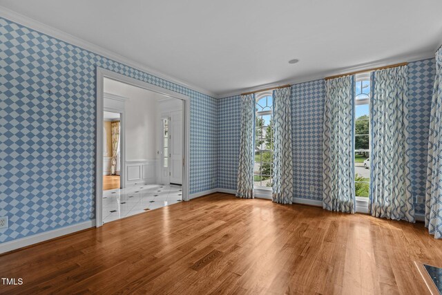 4315 Sugar Pine Ln, Durham, NC 27705 - spare room featuring wallpapered walls, ornamental molding, wood finished floors, and healthy amount of natural light