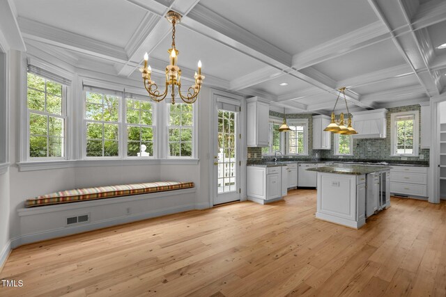 4315 Sugar Pine Ln, Durham, NC 27705 - kitchen with a chandelier, dark countertops, decorative backsplash, coffered ceiling, and white cabinetry