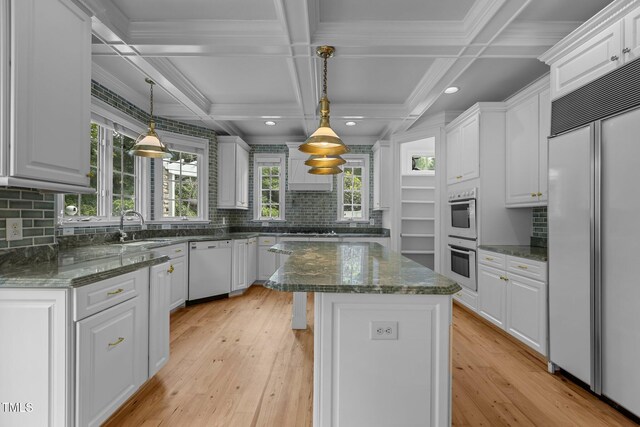 4315 Sugar Pine Ln, Durham, NC 27705 - kitchen with built in fridge, dishwasher, double oven, white cabinetry, and coffered ceiling