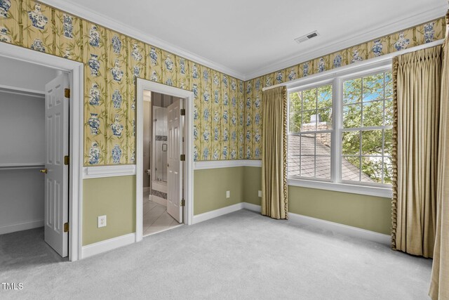 4315 Sugar Pine Ln, Durham, NC 27705 - unfurnished bedroom featuring a walk in closet, wallpapered walls, multiple windows, carpet, and crown molding