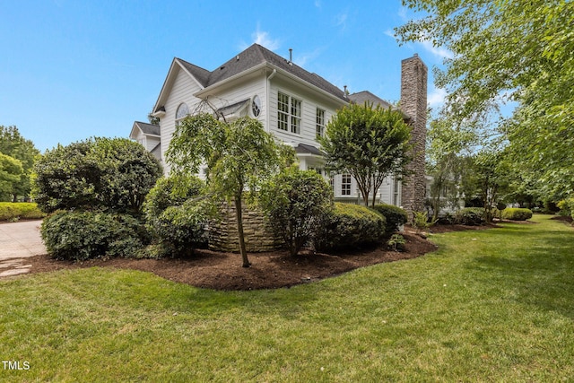 4315 Sugar Pine Ln, Durham, NC 27705 - view of side of home with a chimney and a yard
