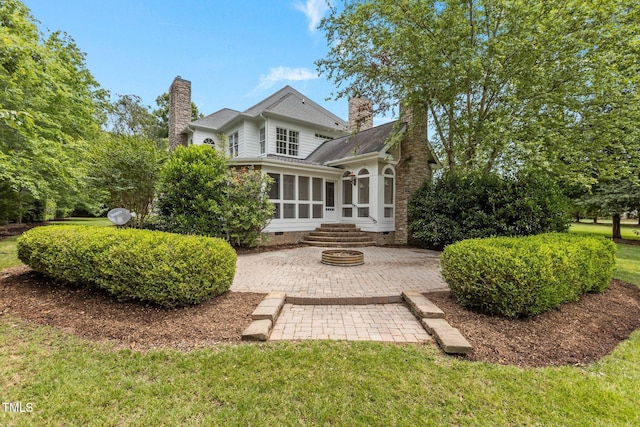 4315 Sugar Pine Ln, Durham, NC 27705 - rear view of house with a chimney, a sunroom, crawl space, a shingled roof, and a patio