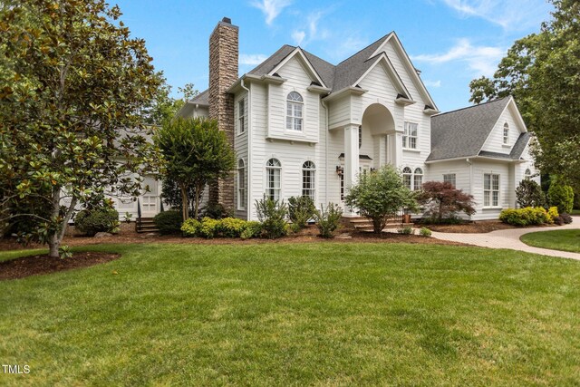 4315 Sugar Pine Ln, Durham, NC 27705 - view of front of property with a chimney, a front lawn, and a shingled roof