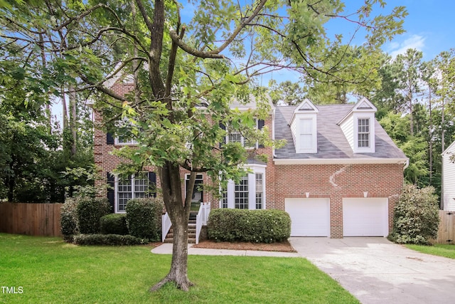 616 Cheselden Dr, Durham, NC 27713 - view of front facade featuring brick siding, concrete driveway, and a garage