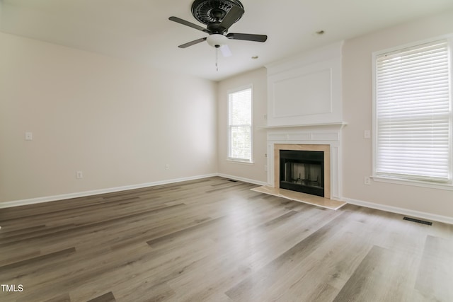 616 Cheselden Dr, Durham, NC 27713 - unfurnished living room featuring a premium fireplace, light wood-style floors, and a ceiling fan