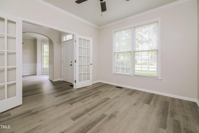 616 Cheselden Dr, Durham, NC 27713 - unfurnished room featuring arched walkways, crown molding, ceiling fan, and wood finished floors