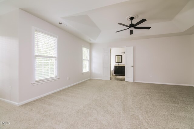616 Cheselden Dr, Durham, NC 27713 - carpeted spare room featuring a tray ceiling and a ceiling fan