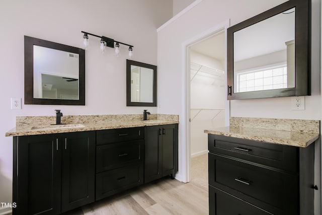 616 Cheselden Dr, Durham, NC 27713 - bathroom featuring wood finished floors, double vanity, and a walk in closet