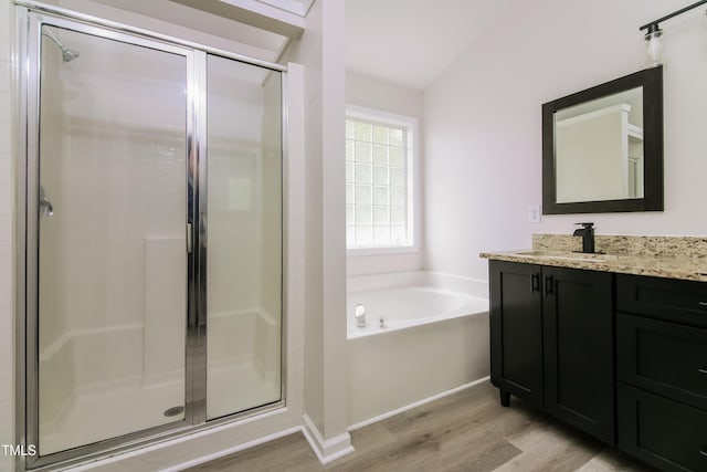616 Cheselden Dr, Durham, NC 27713 - bathroom featuring wood finished floors, vanity, a stall shower, and a bath