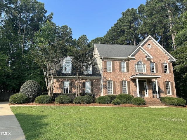 7801 Kingsbrook Ct, Wake Forest, NC 27587 - colonial home featuring a front lawn and brick siding