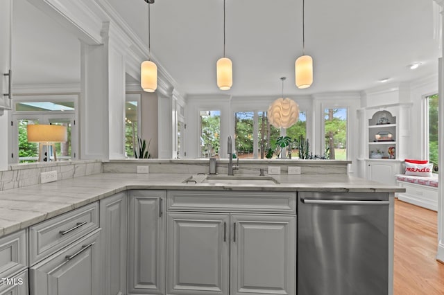 763 Heritage Arbor Dr, Wake Forest, NC 27587 - kitchen featuring stainless steel dishwasher, light stone counters, light wood-style flooring, crown molding, and hanging light fixtures