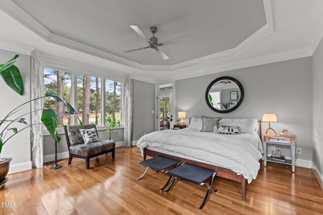 763 Heritage Arbor Dr, Wake Forest, NC 27587 - bedroom featuring a tray ceiling, wood finished floors, crown molding, and a ceiling fan