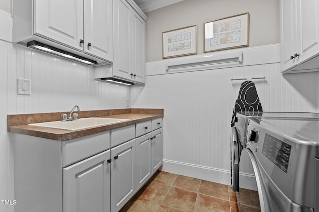 763 Heritage Arbor Dr, Wake Forest, NC 27587 - laundry area featuring washing machine and dryer, cabinet space, wainscoting, and ornamental molding