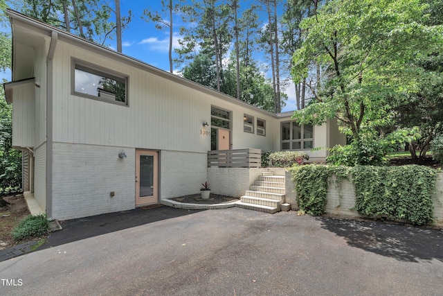 3205 Dell Dr, Raleigh, NC 27609 - view of front facade with brick siding and a patio