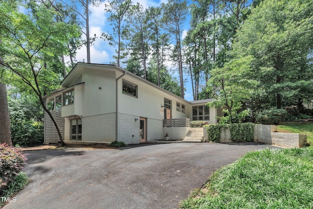 3205 Dell Dr, Raleigh, NC 27609 - view of side of home with brick siding and driveway