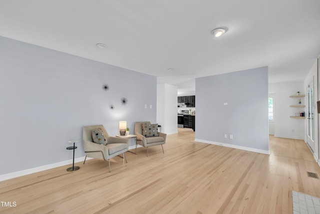 3205 Dell Dr, Raleigh, NC 27609 - sitting room with light wood-style floors and baseboards
