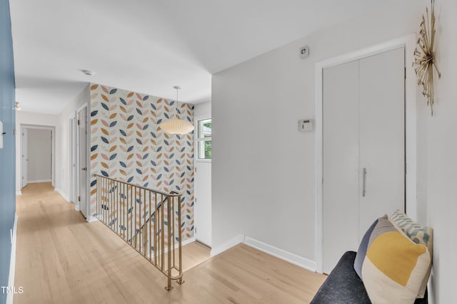 3205 Dell Dr, Raleigh, NC 27609 - corridor with an upstairs landing, wood finished floors, and an accent wall
