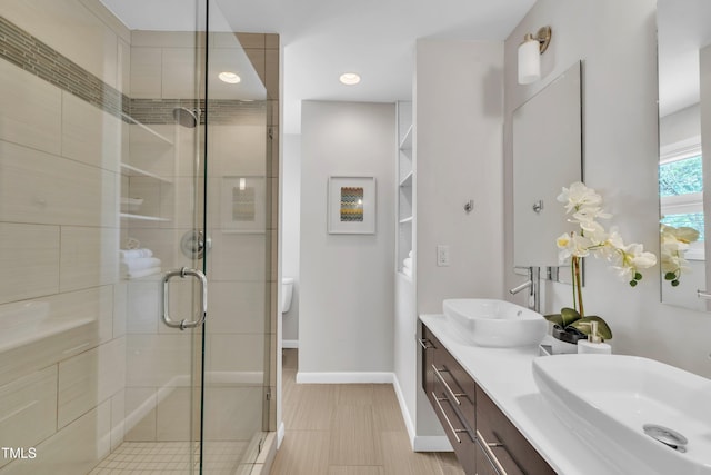 3205 Dell Dr, Raleigh, NC 27609 - bathroom with a stall shower, double vanity, and recessed lighting