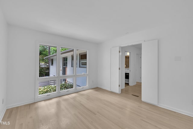 3205 Dell Dr, Raleigh, NC 27609 - empty room featuring light wood-style flooring and baseboards